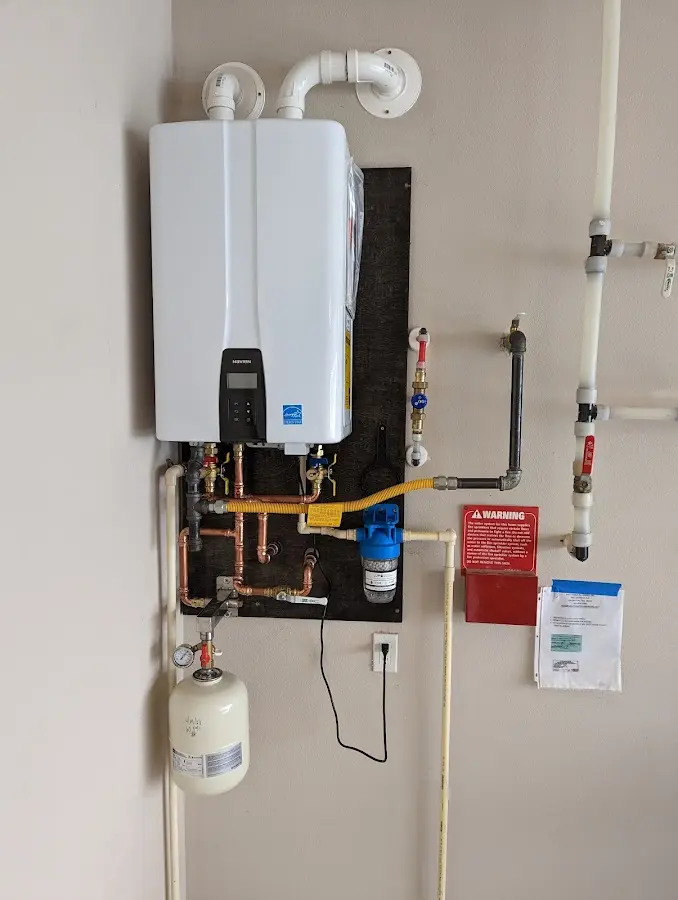 Professional plumber installing copper piping in a Summit Hill home